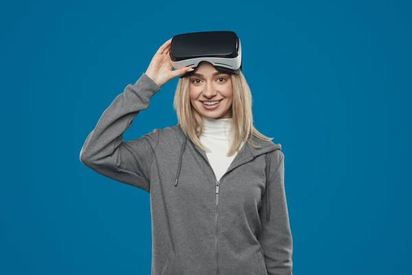 Smiling woman with VR headset looking at camera — Stock Fotó