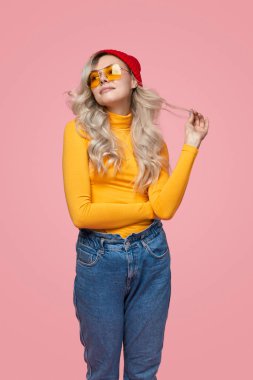 Stylish woman in colorful outfit in studio