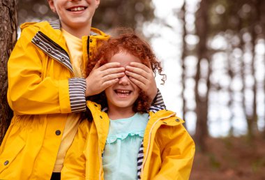 Redhead siblings playing hide and seek game