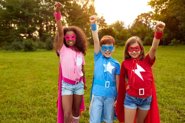 Group of diverse superhero kids standing with fists up — Fotografia de Stock