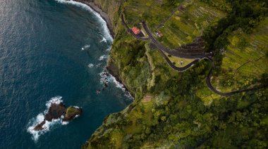 Road and house on cliff near sea