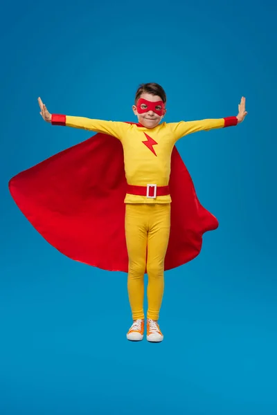 Smiling superhero child in costume in studio — Stock Photo, Image