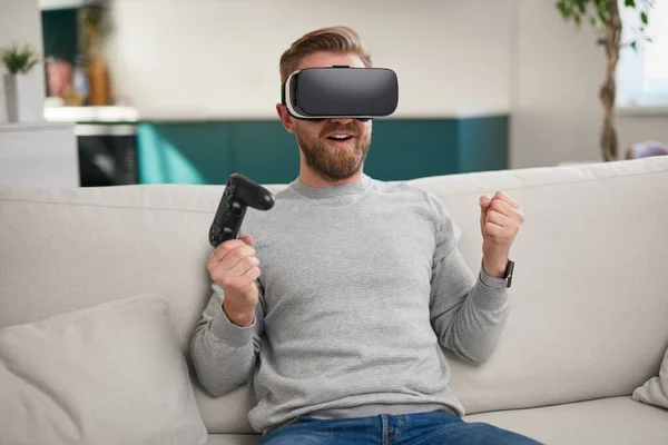 Homem feliz em óculos VR celebrando vitória no jogo — Fotografia de Stock