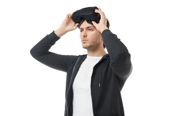 Genç adam VR gözlüklerini beyaz arka plana göre ayarlıyor — Stok fotoğraf