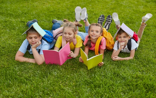 Preteen students with books in park — Stock Photo, Image