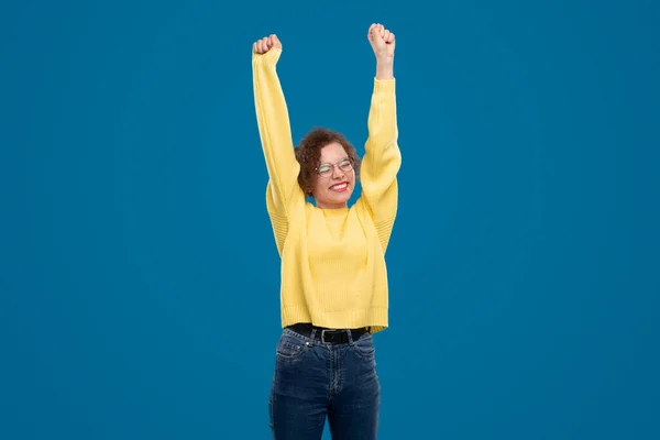 Glad kvinna firar framgång i studio — Stockfoto