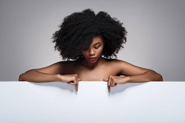 Young Black Woman Curly Hair Bare Shoulders Pointing Empty Poster Royalty Free Stock Photos