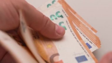 Close up man hands while counting euro money bills. Businessman paying with european banknotes.