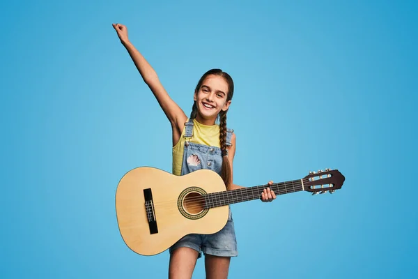 Cheerful Girl Casual Clothes Acoustic Guitar Raising Arm Looking Camera — ストック写真