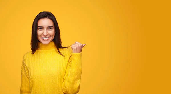 Glad Young Hispanic Brunette Bright Sweater Looking Camera Smile Pointing — 图库照片