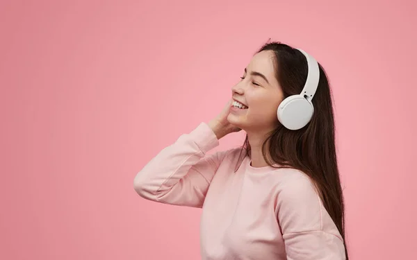 Cheerful Teen Meloman Sweatshirt Touching Wireless Headphones Smiling Closed Eyes — 스톡 사진