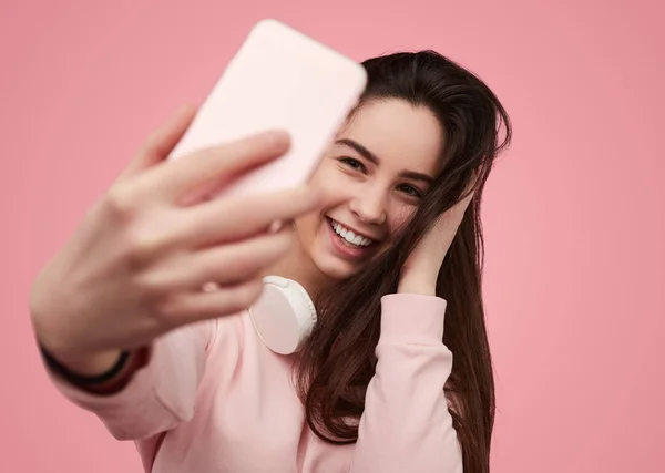 Merry Teenager Sweatshirt Wireless Headphones Touching Hair Smiling While Taking — Stok Foto