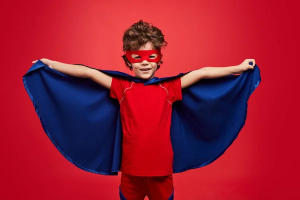 Glad Little Boy Superhero Costume Looking Camera Smile Spreading Cloak — Stockfoto