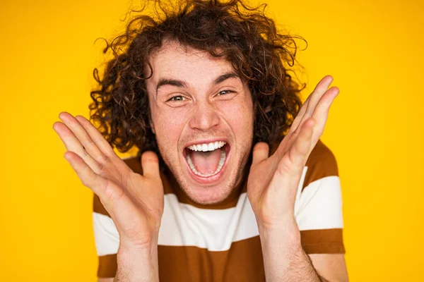 Amazed Young Male Winner Curly Hair Holding Hands Face Yelling — Fotografia de Stock