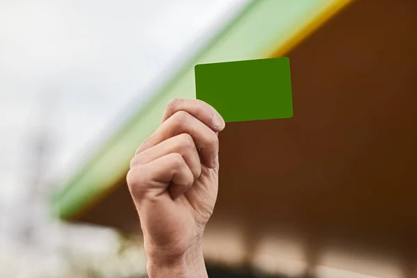Unrecognizable Male Client Demonstrating Green Loyalty Card Raised Arm Visit — Φωτογραφία Αρχείου