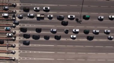 Aerial view timelapse of highway toll collection point with multiple cars on lanes stopping and paying at booths.