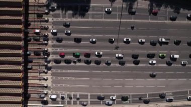 Aerial view of traffic jam before tolls on highway, urban city in Portugal. Multiple cars passing through paid road check point.