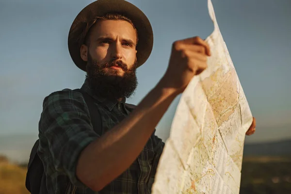 Concentrated Young Bearded Male Traveler Checkered Shirt Hat Holding Paper — Stockfoto