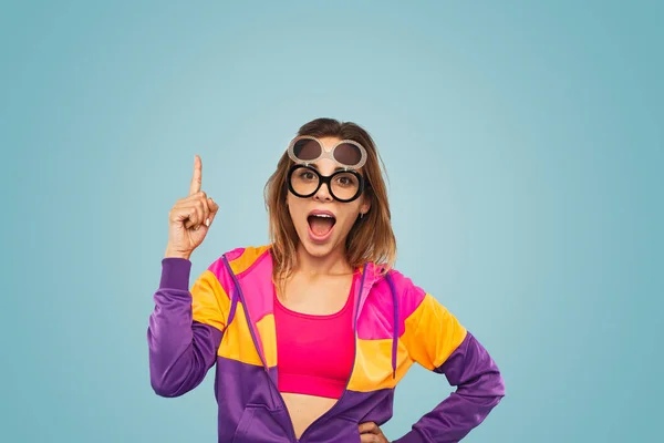 Amazed Young Female Model Trendy Colorful Outfit Creative Sunglasses Pointing — Zdjęcie stockowe