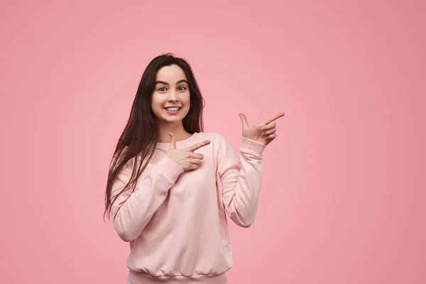 Cheerful Teen Brunette Long Hair Smiling Pointing Away Advertisement Campaign — 스톡 사진