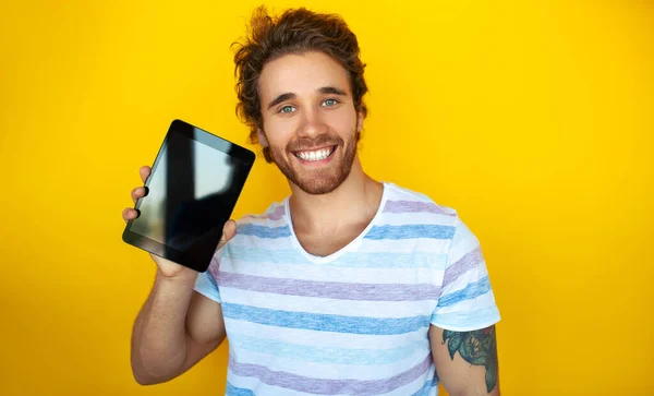 Merry Young Male Striped Shirt Demonstrating Tablet Black Screen Looking —  Fotos de Stock