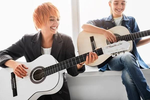 Cheerful Adult Woman Red Hair Jacket Smiling While Playing Acoustic — Foto Stock