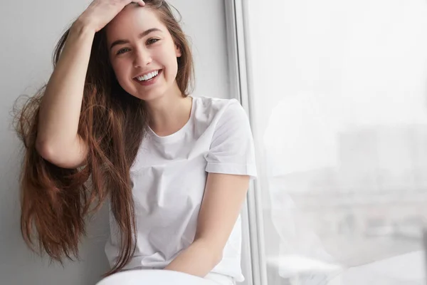 Cheerful Teen Brunette Looking Camera Smile Touching Long Hair While — Zdjęcie stockowe