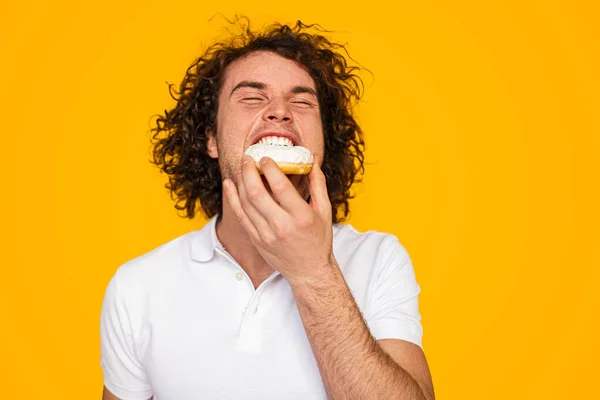 Happy Young Hungry Man Curly Dark Hair Polo Shirt Eating — Stockfoto