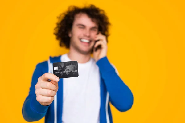 Soft Focus Cheerful Young Man Demonstrating Credit Card Smiling While — Stockfoto