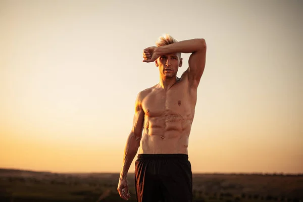 Determined Young Muscular Shirtless Male Athlete Wiping Sweat Forehead While — Stok Foto