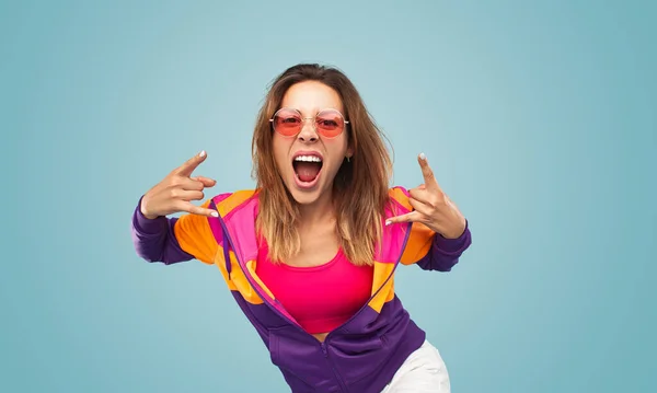 Young Female Colorful Clothes Sunglasses Showing Horns Gesture Screaming Camera — Stock Fotó