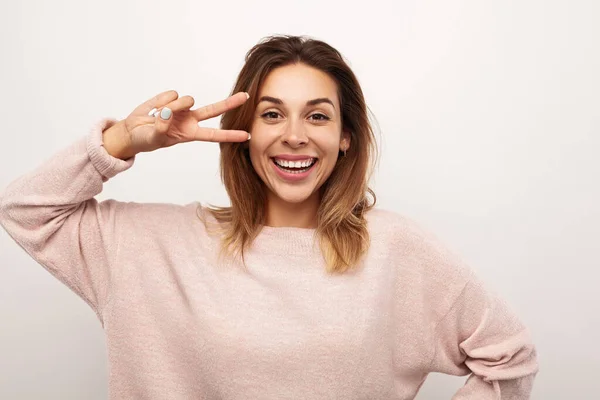 Happy Young Female Soft Pink Sweater Showing Two Fingers Gesture — Fotografia de Stock