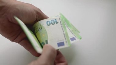 close-up of man hands counting a pile of 100 euros banknotes. Man counting cash. money exchange concept