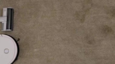 Vacuum Robot auto cleaning and classical vacuum cleaner working together at home on carpet. Comparison and competition between generations in housekeeping technology