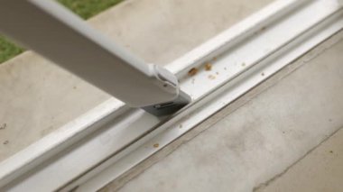 Vacuuming crumbs and dirt from doorway with modern vacuum cleaner 