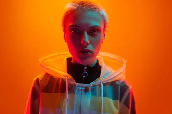 Young Woman Futuristic Raincoat Short Hair Standing Colorful Neon Illumination — Stock Photo, Image