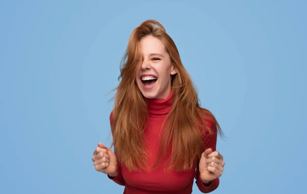 Happy Young Redhead Female Red Turtleneck Clenching Fists Shouting Excitement — Stock Photo, Image