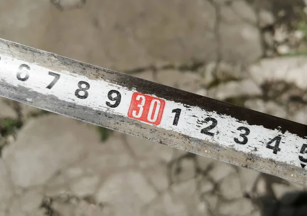 The red number is 30 per meter for measuring length. The highlighted number 30 against the background of asphalt. — Stock Photo, Image