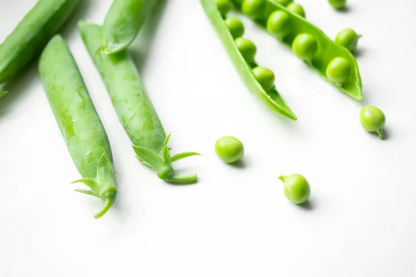 White Background Green Peas Pods Throats Scattered White Table Green — Zdjęcie stockowe