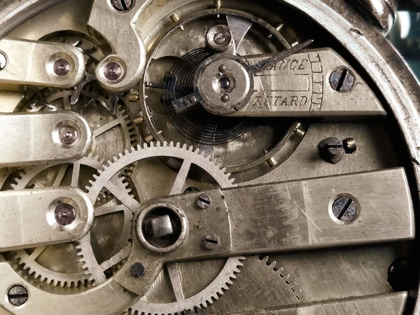 Gears and other parts of mechanical watches. Hand watch in macro photography - the back part. Clock working gears. The inside of an old clock.