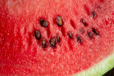 Watermelon pulp is a close shot. The red flesh of a watermelon with seeds is a close camera shot. Macrophoto watermelon.