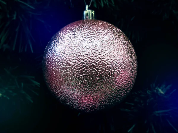 Ağacın üzerinde desenli inci rengi Noel oyuncağı. 