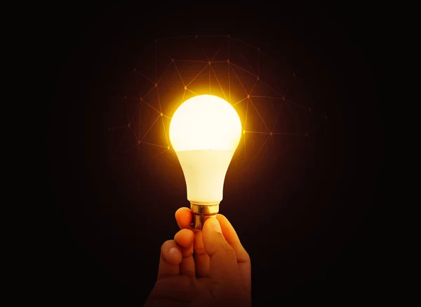 Glowing Bulb with Futuristic Technological Evolution Concept. Ideas generating backdrop glowing bulb in the hand.