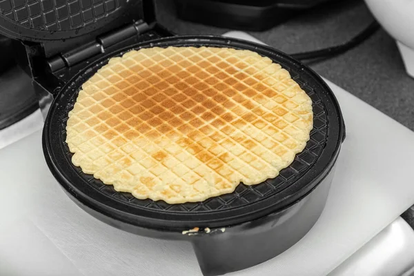 The waffles are baked in an electric waffle iron. Homemade baking. Close up. — Stock Photo, Image