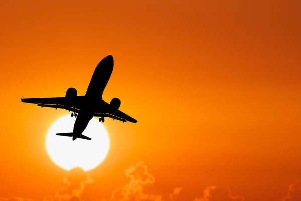 Silhouette of a passenger plane taking off from the airport. Tourist flights after the Covid-19 crisis