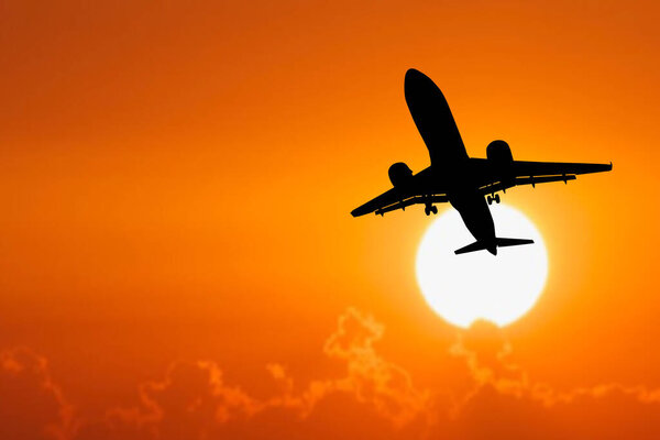 Silhouette of a passenger plane taking off from the airport. Tourist flights after the Covid-19 crisis