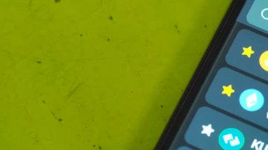 phone screen with stocks market app  on background, close up