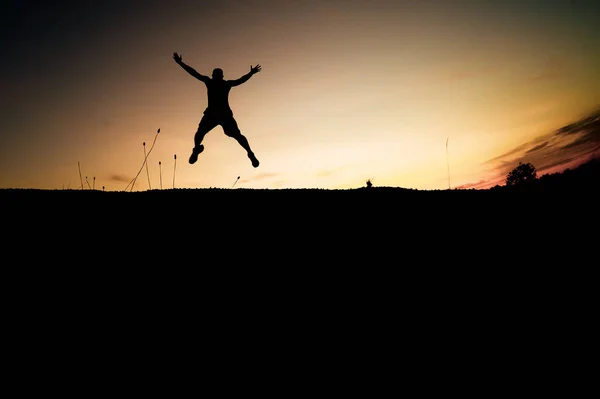 Silhouettes Men Jumping Joy Freedom Beautiful Light Evening — Stock Photo, Image
