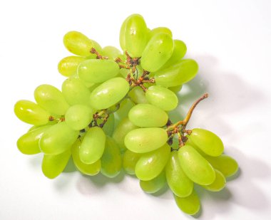 Beyaz arka planda izole edilmiş yeşil üzüm demeti. Yapraklı taze yeşil üzümler. Beyazda izole edilmiş. Stok fotoğrafı. Tatlı ve lezzetli olgun yeşil üzüm