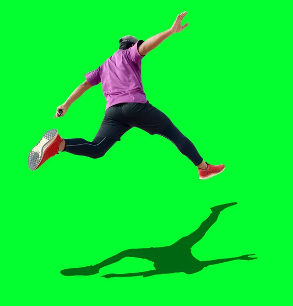 Male Runner Jumping Isolated Green Background Copy Space — Stock Photo, Image